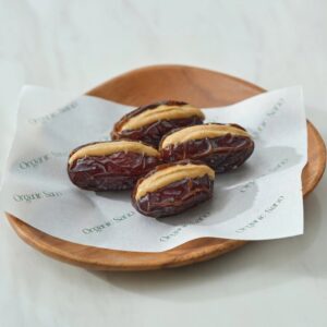 Organic Sano vanilla cashew butter stuffed dates on a wooden plate