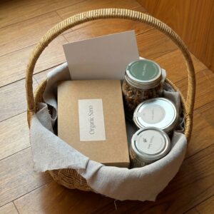 The Women's Wellness Hamper by Organic Sano in a round wicker basket